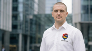 A security guard and CCTV camera illustrating the difference between manned guarding and CCTV monitoring.